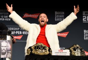 NEW YORK, NY - NOVEMBER 10: UFC featherweight champion Conor McGregor of Ireland takes the belt of lightweight champion Eddie Alvarez (not pictured) during the UFC 205 press conference inside The Theater at Madison Square Garden on November 10, 2016 in New York City. (Photo by Jeff Bottari/Zuffa LLC/Zuffa LLC via Getty Images)