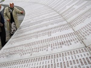 Bosnian Muslim couple Suhra Malic (2nd L) and Hasan Malic look at a memorial to victims of the 1995 Srebrenica massacre in Potocari near Srebrenica October 26, 2009 before court proceedings for former Bosnian Serb leader Radovan Karadzic. Karadzic refused to attend the start of his war crimes trial on Monday, and judges said they could appoint a lawyer to represent him if he failed to show up again. The Bosnian Serb political leader is charged with genocide over the massacre of 8,000 Bosnian Muslim men and boys at Srebrenica in July 1995. He is also charged over the 43-month siege of the Bosnian capital Sarajevo by Serb forces. REUTERS/Dado Ruvic (BOSNA AND HERZEGOVINA CRIME LAW CONFLICT) - GM1E5AQ1GJM01