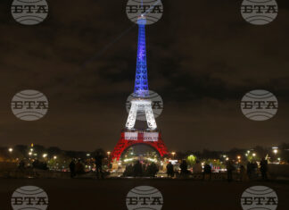 10 години от терористичните нападения в Париж – нощта, която промени Франция Хора гледат Айфеловата кула, осветена в цветовете на френското знаме в памет на жертвите на атентатите от 13 ноември.