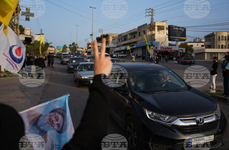 Разселени от войната ливанци се завръщат по селата си, а местни жители развяват знамена на "Хизбула" и плакат с лика на предишния лидер на групировката Хасан Насрала в Южен Ливан след обявяването на прекратяване на огъня между Израел и "Хизбула".