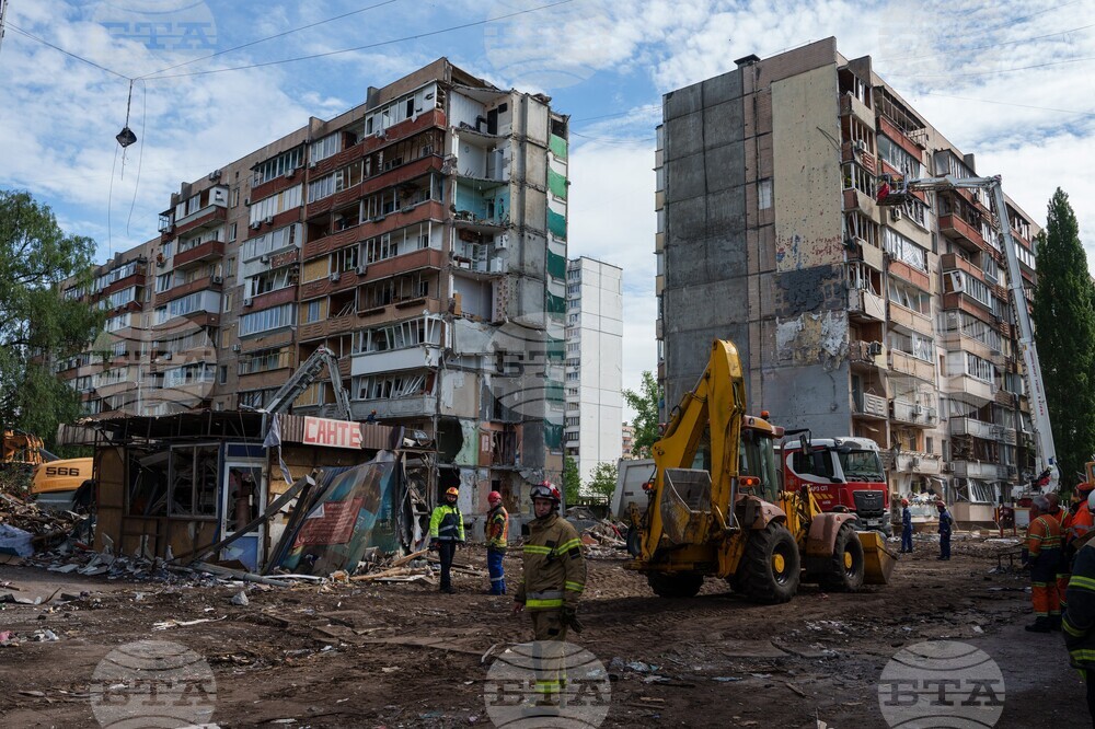 Спасители пред жилищна сграда, повредеена при руски удар в жилищен квартал в Киев, 15 май 2026 година